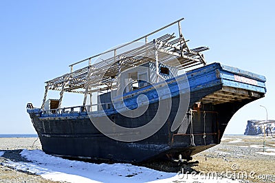 Abandoned North Korean fishing schooner on the shore of the Sea of â€ÂÃ‚Ââ€¹â€ÂÃ‚Ââ€¹Japan, Primorye, Russia. Stock Photo